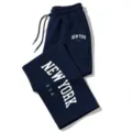 Dark blue sweatpants detail showing white New York letter print and adjustable drawstring waist. - Navy Blue