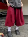 Detailed closeup view of mens casual wide leg burgundy shorts, loose streetwear style. - S / Red