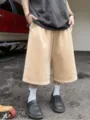 Men casual loose solid color wide leg cropped shorts detail showcasing streetwear style design - Khaki