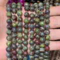 Detailed macro view of natural dragon blood jasper round stone beads for DIY jewelry making - Dragon Blood Stone