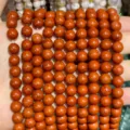 Detailed macro view of polished natural red jasper round beads for DIY jewelry making - Red Jasper