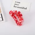 Close-up of large red marbled acetate hair claw clip with elegant fan-shaped design - Red Floral