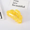 Detailed macro view showing the glossy texture of a yellow marble acetate hair claw clip - Yellow Floral