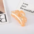 Detailed view of elegant orange marble pattern acetate hair claw clip on a white surface - Orange Red Floral