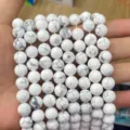 Detailed view of white howlite stone round beads with grey marble patterns for DIY. - Howlite