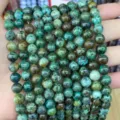 Close-up detail showing the natural textures of green stone round beads for DIY jewelry - African Pine
