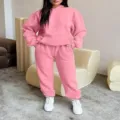 Detail shot of women casual pink hoodie and sweatpants tracksuit set in modern interior setting. - S / Top And Bottom / Pink