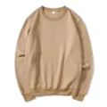 Close-up detail of a plain khaki crewneck sweatshirt featuring long sleeves and ribbed hem. - Camel