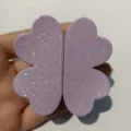 Close-up detail of a purple magnetic four-leaf clover hair clip with sparkling glitter surface. - Iridescent Purple Four-Leaf Clover Magnetic Hair Clip