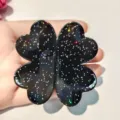 Smart magnetic hair clip with stylish four leaf clover design and glitter finish for use. - Iridescent Black Four-Leaf Clover Magnetic Hair Clip