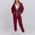 Detailed view of women's casual burgundy zip hoodie and comfortable tracksuit set. - Burgundy