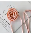 Close-up detail of the pink fabric rose flower tie necklace, showing soft texture and fine craft. - Satin Style / Pink