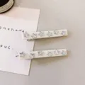 Elegant white star hair clips with sparkling rhinestones for cute daily styling and bangs. - Cream White Silver Star Style (1) / 2 Pcs/Set