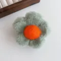 Fluffy green flower hair claw clip with orange center, cute plush hair accessory. - Green