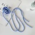 Light blue fabric rose choker necklace with long ribbon ties, elegant floral jewelry accessory. - Satin Style / Blue