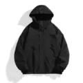 Black hooded waterproof windbreaker jacket detail view, showing high-collar and adjustable cuffs. - S / Tops / Black