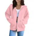 Pink zip-up hoodie detail view showcasing casual oversized fit, drawstring hood and pockets. - S / Tops / Lotus Pink