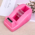 Pink desktop tape dispenser with sharp metal blade and clear core for office school use. - Rose Red