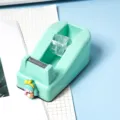 Mint green cute cartoon girl desktop tape dispenser variant featuring a sharp metal cutter. - Mint Green