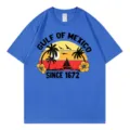 T-shirt à manches courtes en coton bleu avec imprimé graphique de coucher de soleil tropical. - S / Hauts / Bleu saphir
