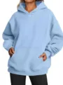 Oversized light blue hoodie detail showcasing drop shoulder sleeves and front kangaroo pocket. - Light Blue