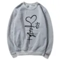 Grey crewneck long sleeve sweatshirt for women featuring a faith heart and cross graphic print. - Light Gray