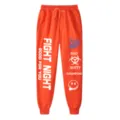 Pantalone jogger streetwear arancione con stampe di lettere alla moda e design hip hop. - Taglia S / Pantaloni e gonne / Arancione e bianco