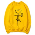 Yellow crewneck sweatshirt for women featuring a faith heart graphic print, long sleeve casual top. - Yellow