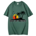 Classic green cotton short sleeve t-shirt featuring a scenic sunset palm tree graphic design. - S / Tops / Dark Green