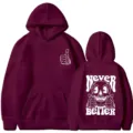 Burgundy hooded sweatshirt with front pocket and skull text print, casual streetwear style. - Burgundy