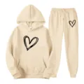 Beige hooded sweatshirt and matching sweatpants set featuring a stylish black heart print. - S / Top And Bottom / Khaki