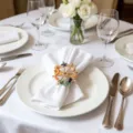 Detailed view of nautical napkin ring with seahorse, starfish and octopus on white table napkin. - Rudder Seahorse Octopus Style