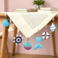 Mollette per tovaglia stile oceano con simpatici motivi di conchiglie e timone per decorazione. - Assortimento Misto Oceano Mediterraneo