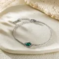 Silver-colored chain bracelet featuring a green irregular zircon stone, elegant daily jewelry. - Irregular Shape Bracelet (C419) / Silver with Green Zirconia