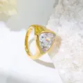 Detail view of a stylish gold stainless steel ring featuring a sparkling trillion cut cubic zirconia. - Size 7 / Gold