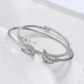 Primo piano di un elegante bracciale rigido in argento con dettagli di foglie in zircone. - Stile Foglia Argentato (2)