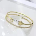 Elegante set di bracciali rigidi a serpente e bracciale tennis in zircone placcato oro 18K. - Stile Osso di Serpente Dorato (G3)