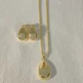 Detailed view of gold plated teardrop pendant necklace and matching pave heart earrings set. - Heart (G Heart)