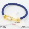Detailed view of the blue braided leather bracelet with gold pavé U-link clasp and sparkling stones. - Blue