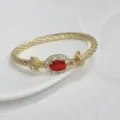 Luxury 18K gold plated twisted cable cuff bracelet featuring oval red cubic zirconia for women - Gold and Red