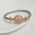 Luxury cable wire cuff bracelet with pink cubic zirconia round center and 18k gold plated. - Pink