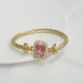Gold plated twisted cable bracelet with a sparkling rectangular pink zircon detail. - Gold Pink