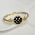 Luxury gold cable twist bangle bracelet with black and white zircon round centerpiece jewelry - Black Frill Bow