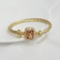 Gold cable bracelet with rectangular gemstone and micro-inlaid zirconia square buckle. - Gold-Tone Champagne