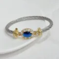 Luxury oval blue zircon twisted cable bracelet in gold and silver two-tone metal finish. - Silver Blue