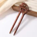 Close-up detail view of a retro carved red sandalwood hairpin with delicate bamboo motif craftsmanship. - Bamboo Joint