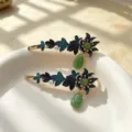 Close-up detail shot of exquisite Chinese style enamel floral hair clips with jade pendants. - Green Pendant Indigo Floral Leaf Alligator Clips (Two-Piece Set)