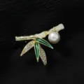 Elegante broche en forma de bambú con perla, pedrería brillante y detalles de esmalte verde. - Bambú / Dorado y Verde