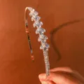Detailed shot of a sparkling rhinestone thin hair hoop with exquisite cubic zirconia design. - Fish Tail Shape (Fish Tail)