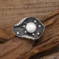 Detailed shot of retro Chinese style lotus leaf pearl brooch with sparkling crystals and metal. - Lotus Leaf Style / Lotus Leaf White Pearl